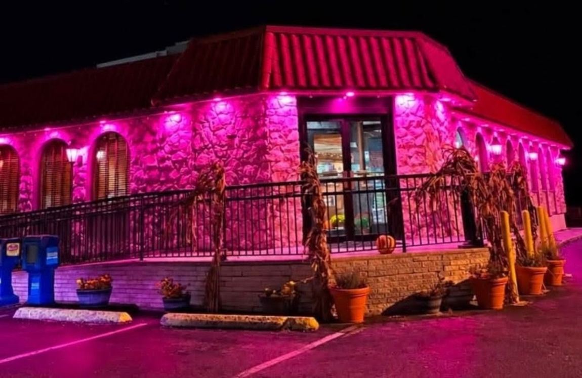 Community building illuminated magenta