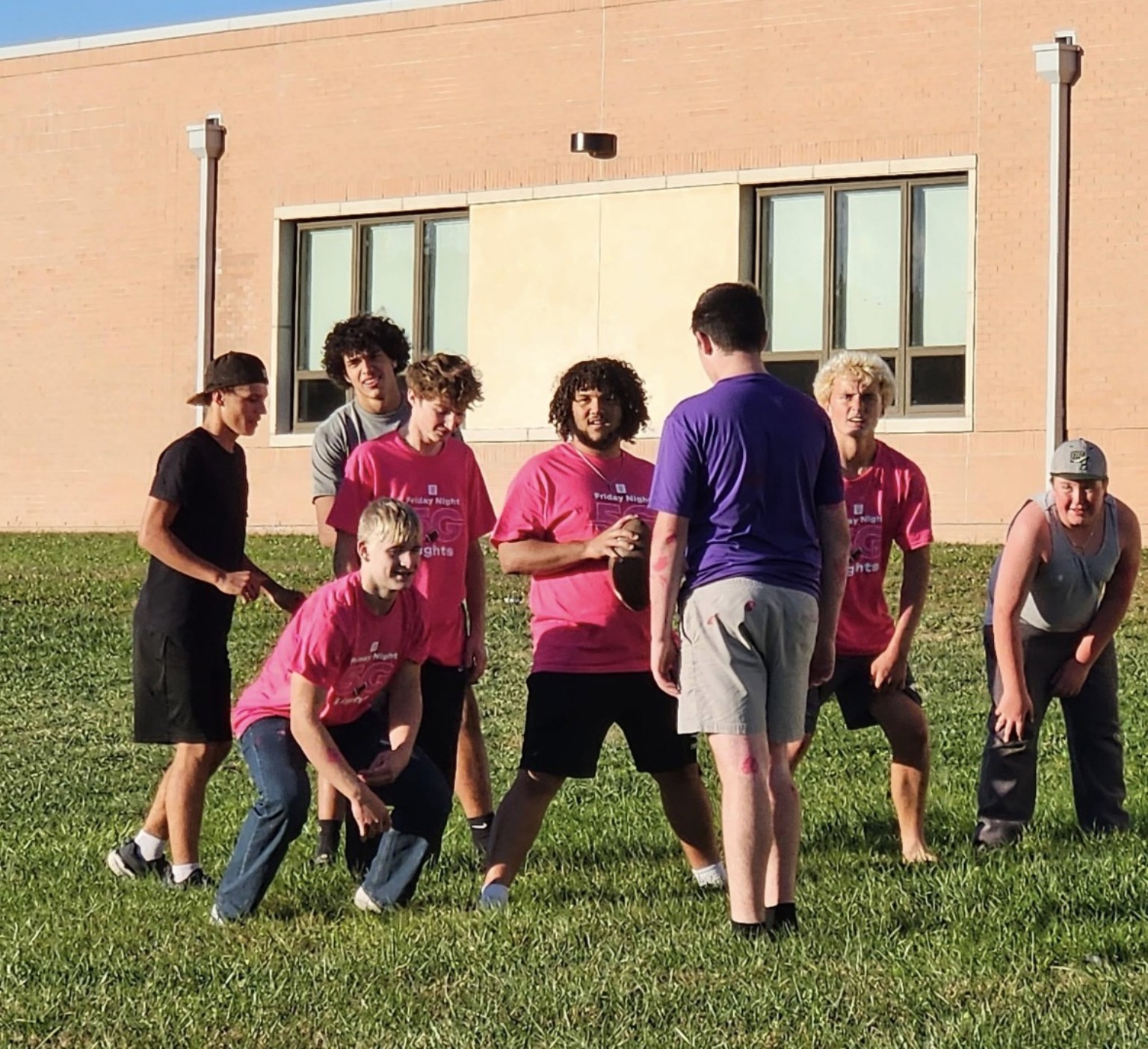 Mustang players together outside in their spirit challenge shirts